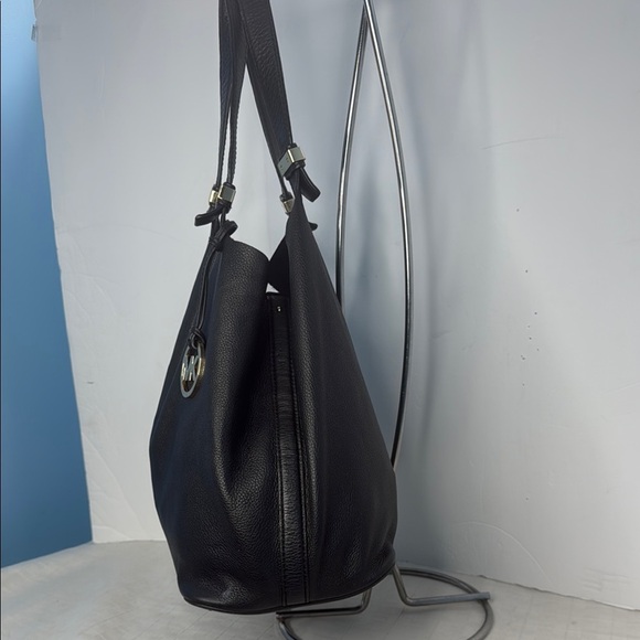 The image shows a Michael Kors Colgate Reversible Grab Bag in black. - Picture 2 of 11